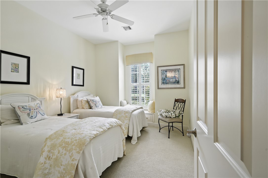 620 Bridgewater Lane Southwest Vero Beach, FL 32962 - Photo 18 of 31 a bedroom with a bed and a chandelier