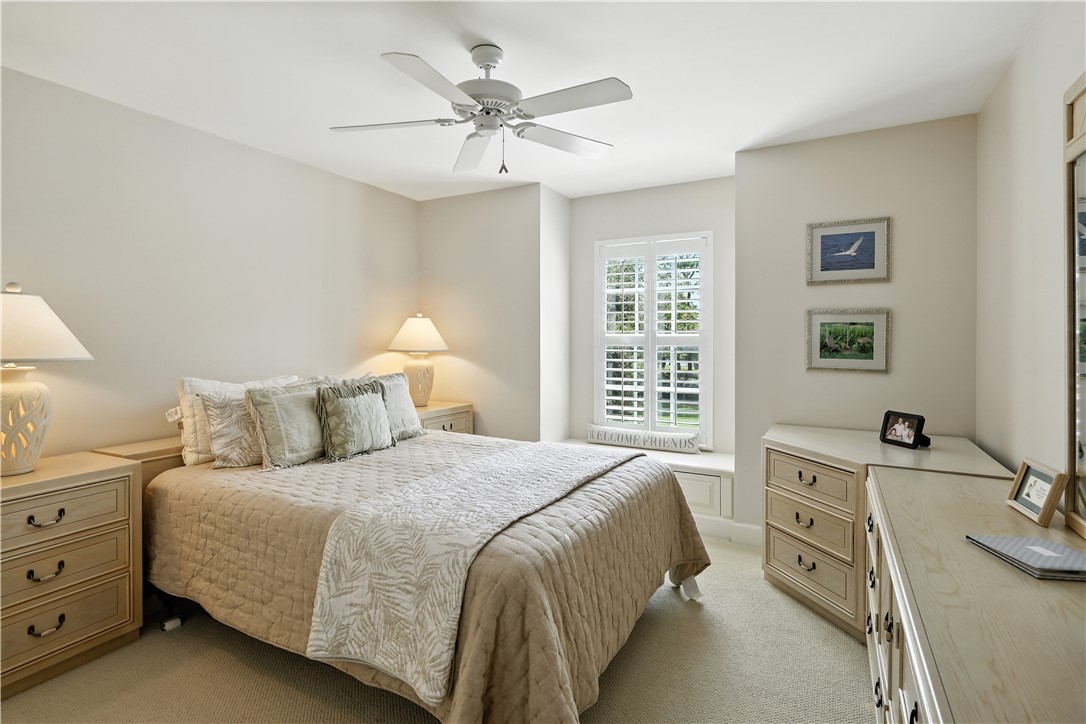 620 Bridgewater Lane Southwest Vero Beach, FL 32962 - Photo 19 of 31 a bedroom with a bed and a chandelier