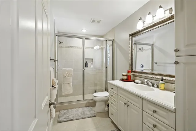 a bathroom with a double vanity sink mirror double and shower