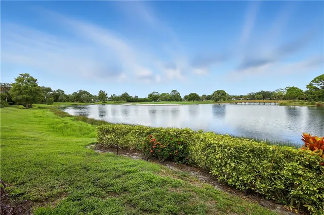 a view of a lake with houses in the back