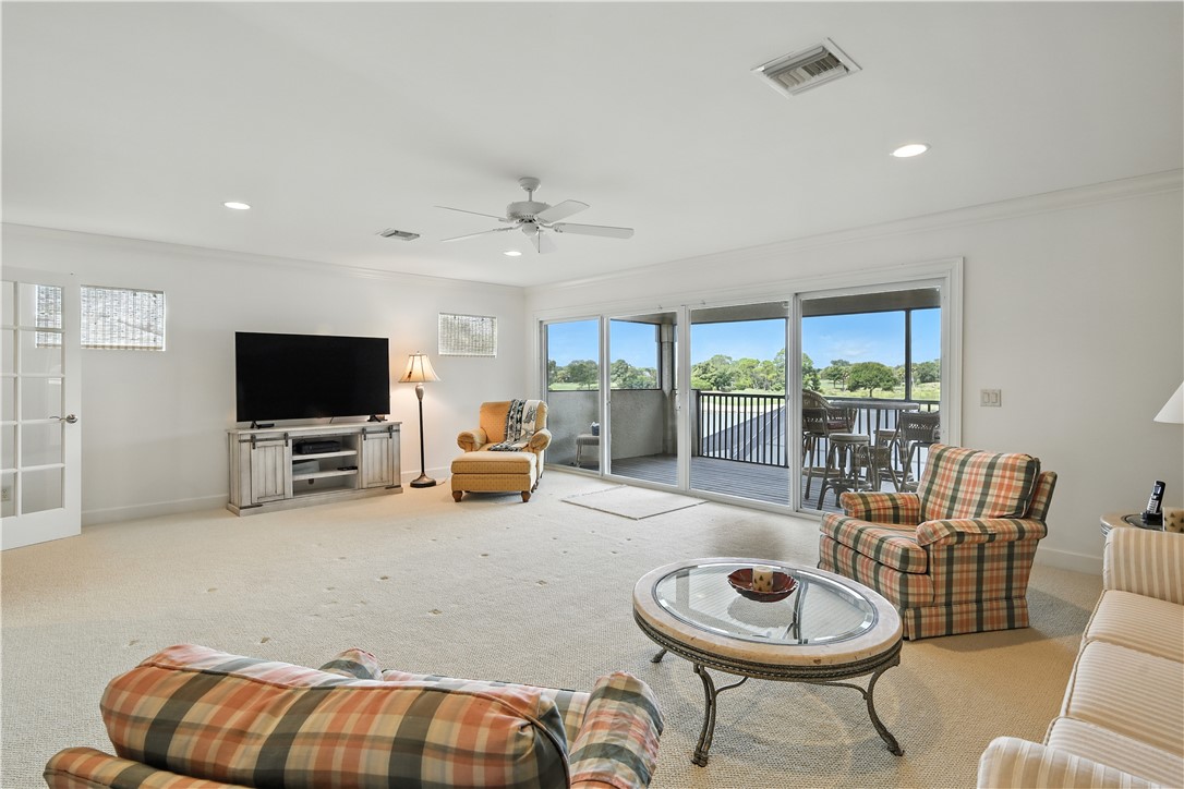 620 Bridgewater Lane Southwest Vero Beach, FL 32962 - Photo 23 of 31 a living room with furniture and a flat screen tv