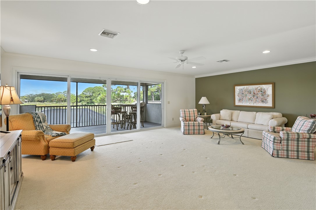 620 Bridgewater Lane Southwest Vero Beach, FL 32962 - Photo 24 of 31 a living room with furniture and a flat screen tv