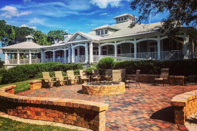 a view of a house with swimming pool and sitting area