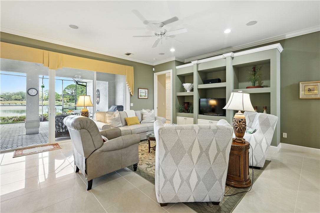 620 Bridgewater Lane Southwest Vero Beach, FL 32962 - Photo 5 of 31 a living room with furniture and large windows
