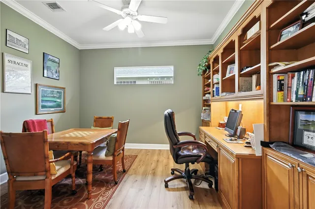 a view of a workspace with furniture and a bookshelf
