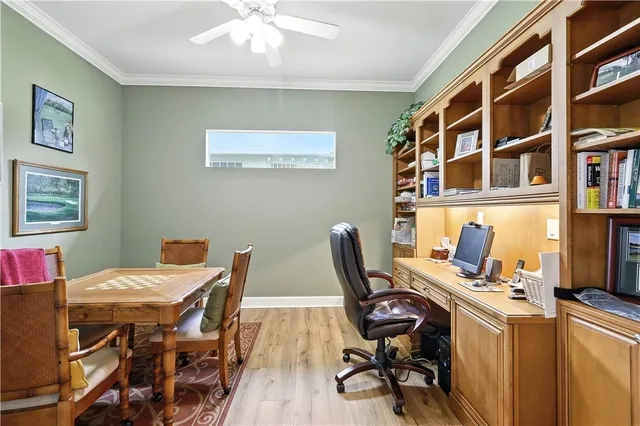 a view of a workspace with furniture and a bookshelf