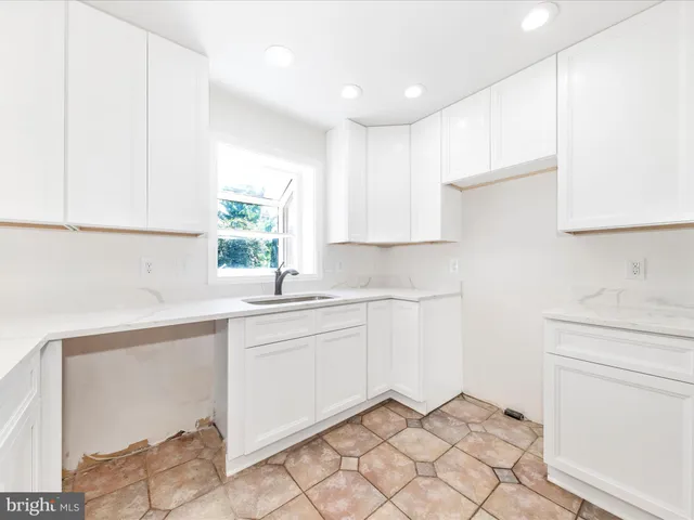a kitchen with a sink cabinets and window