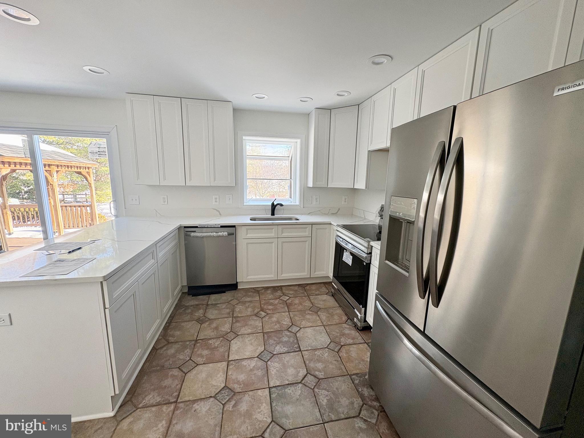 8395 Buckeye Court Frederick, MD 21702 - Photo 11 of 56 a kitchen with a refrigerator sink and cabinets