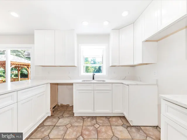 a kitchen with a sink cabinets and window