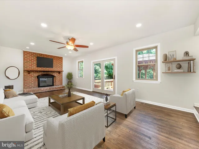 a view of empty room with wooden floor and fireplace