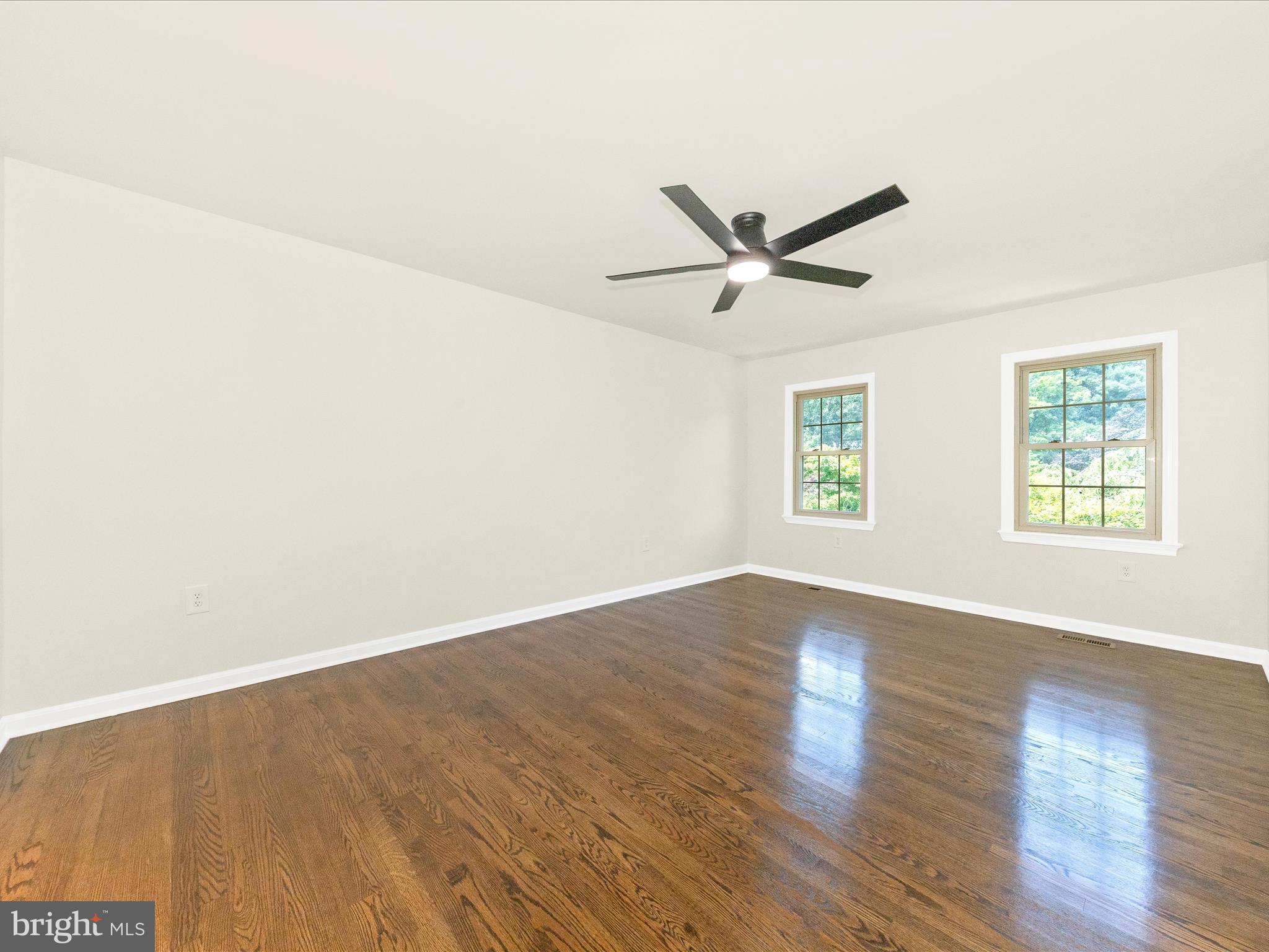 8395 Buckeye Court Frederick, MD 21702 - Photo 22 of 56 an empty room with wooden floor and windows