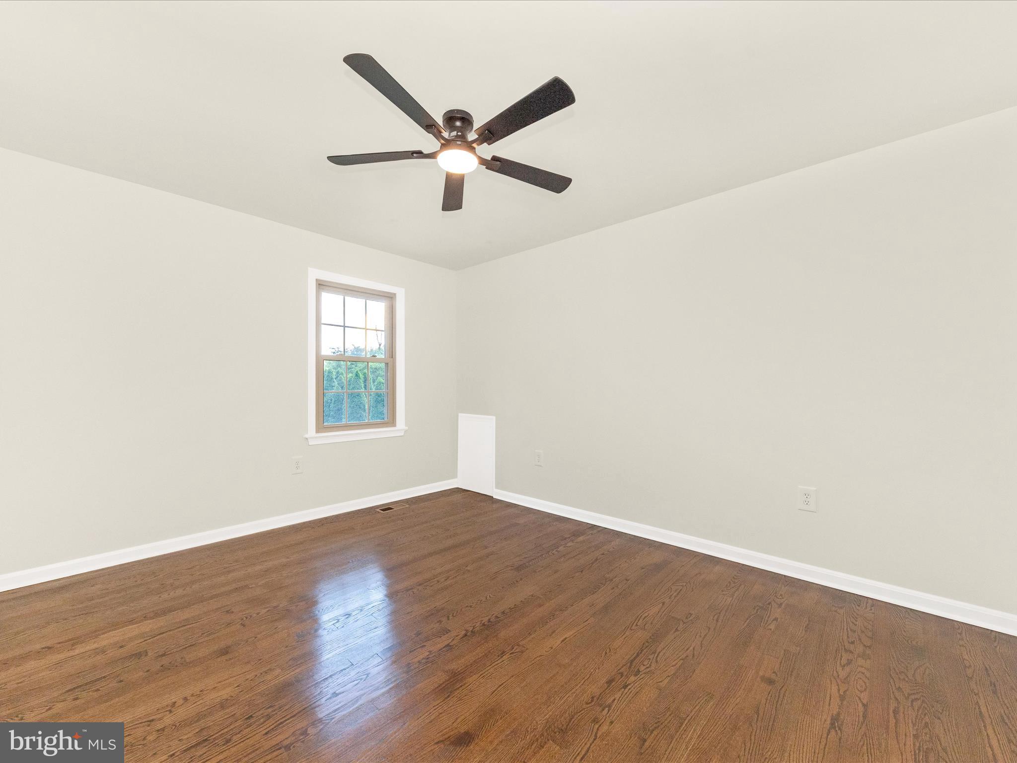 8395 Buckeye Court Frederick, MD 21702 - Photo 26 of 56 an empty room with wooden floor fan and windows