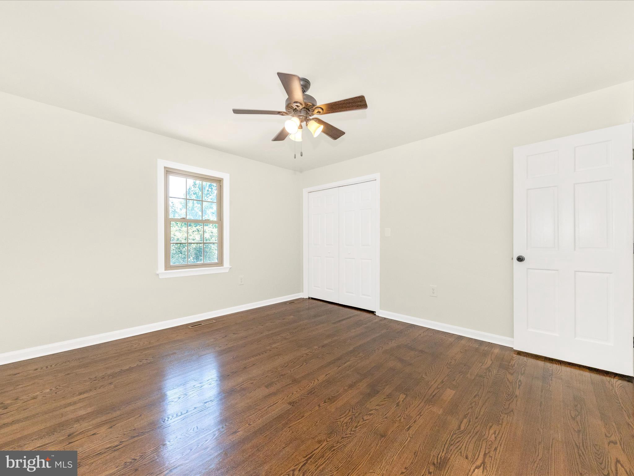 8395 Buckeye Court Frederick, MD 21702 - Photo 29 of 56 an empty room with wooden floor fan and windows
