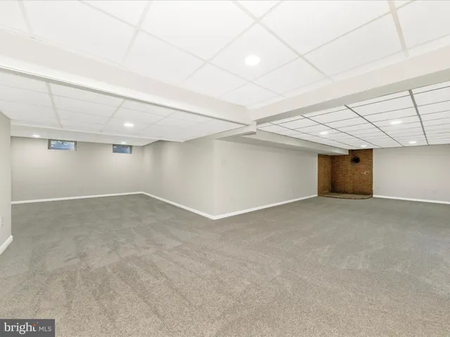 a front view of a building with a garden and plants