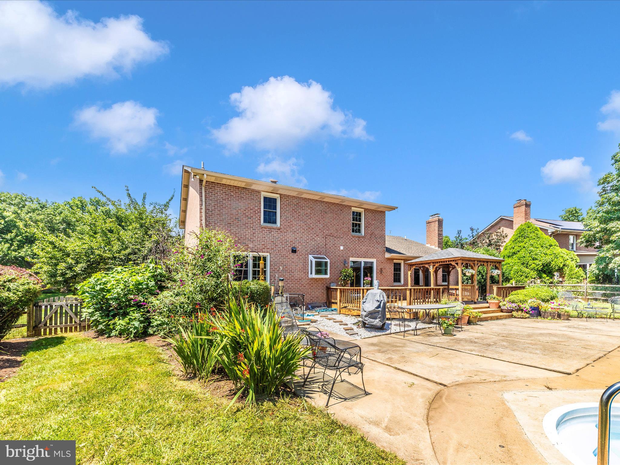 8395 Buckeye Court Frederick, MD 21702 - Photo 43 of 56 a front view of a building with a garden and plants