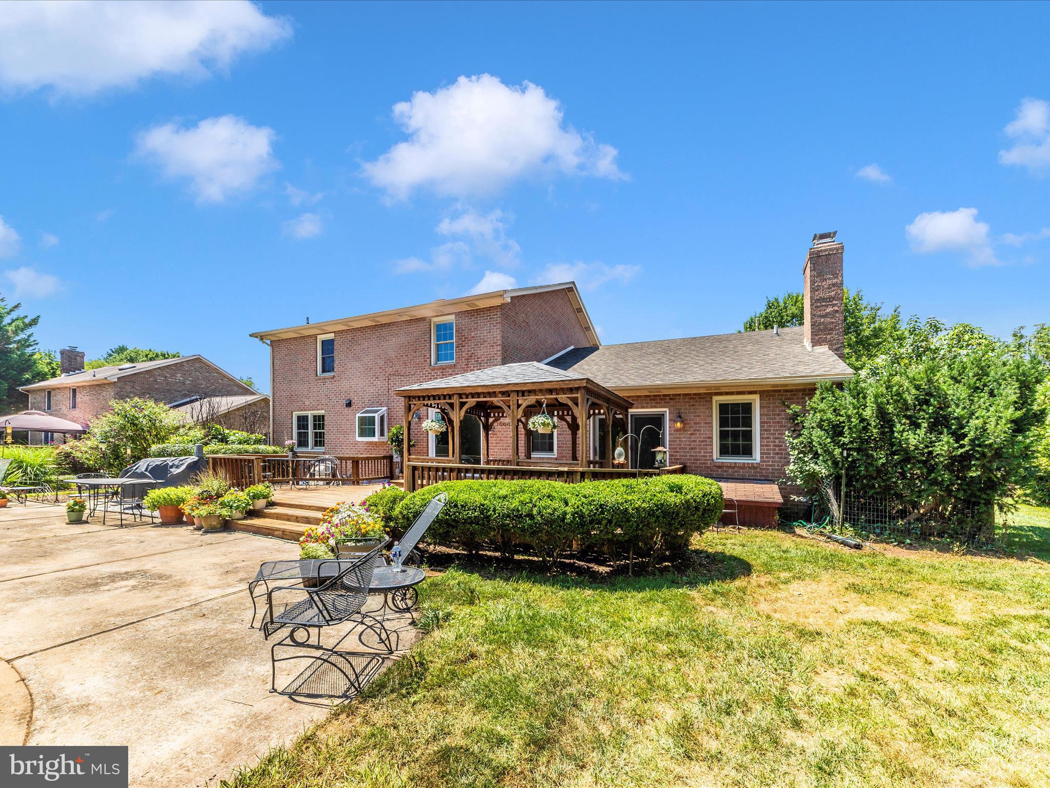 8395 Buckeye Court Frederick, MD 21702 - Photo 45 of 56 a front view of a house with garden and porch