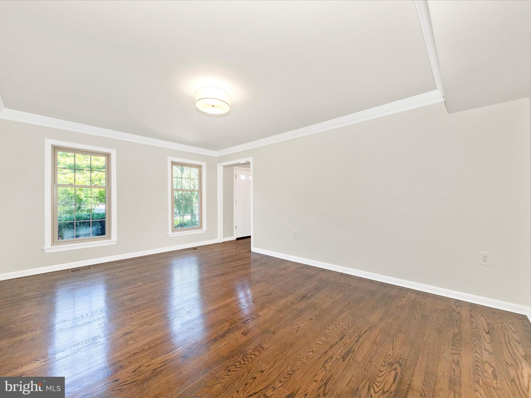 8395 Buckeye Court Frederick, MD 21702 - Photo 5 of 56 an empty room with wooden floor and windows