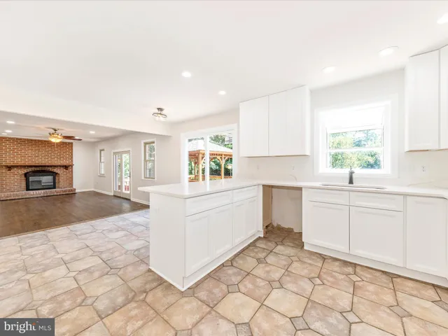 a kitchen with a sink cabinets and window