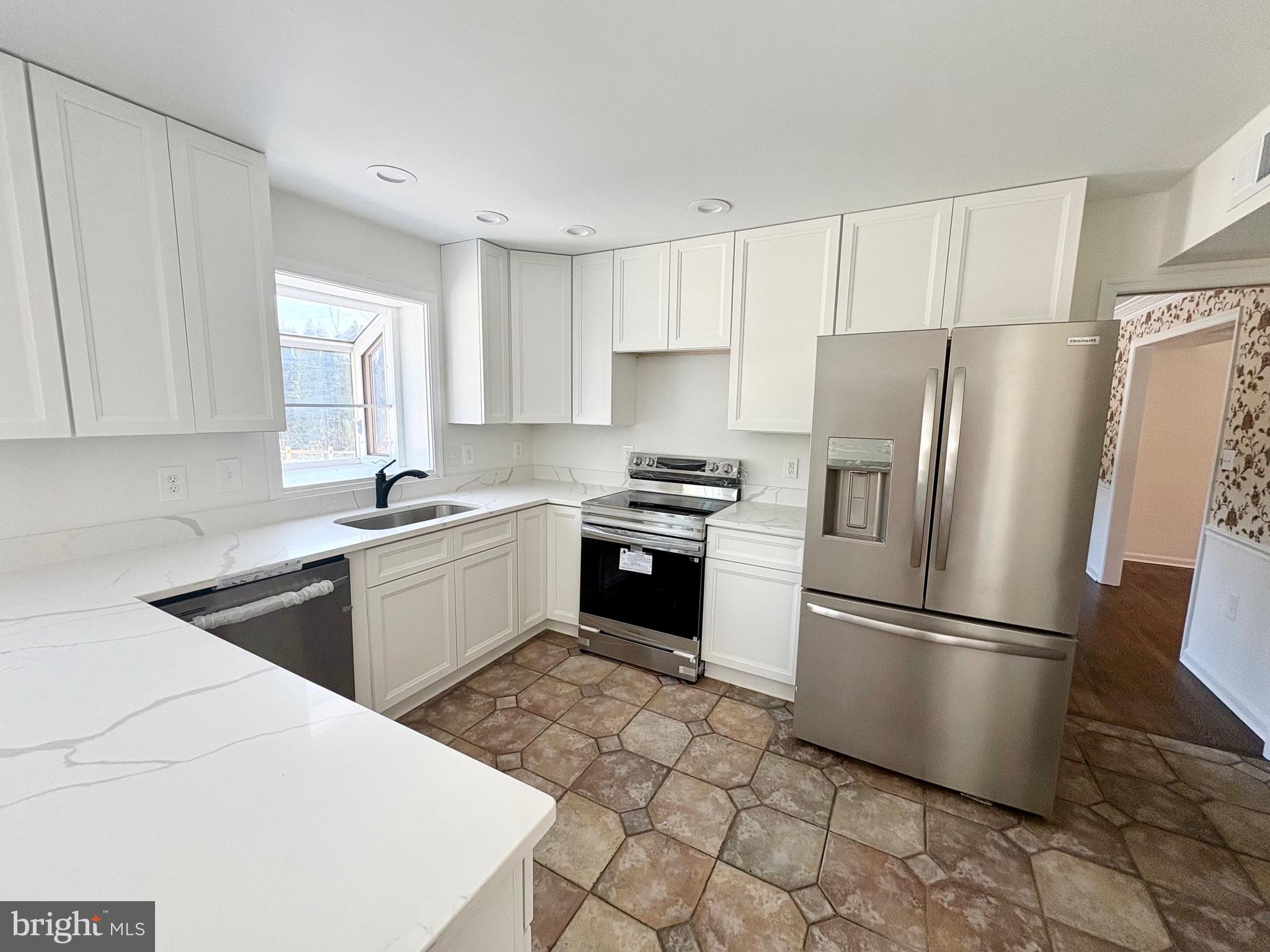 8395 Buckeye Court Frederick, MD 21702 - Photo 10 of 56 a kitchen with a refrigerator sink and cabinets