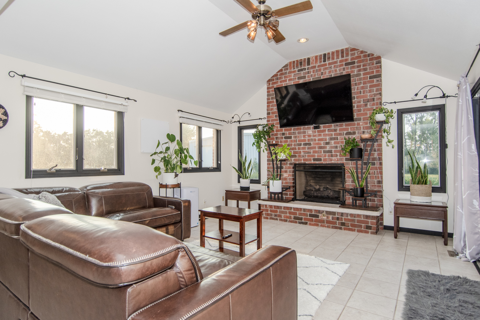 1450 Airport Road Morris, IL 60450 - Photo 21 of 43 a living room with furniture a flat screen tv and a fireplace