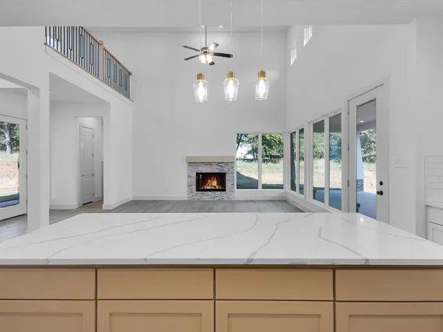 a large kitchen with granite countertop a large counter top and sink