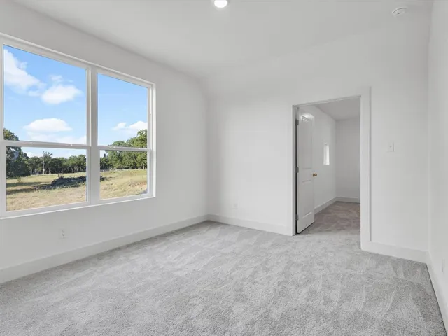 a bathroom with a bathtub shower sink vanity mirror and toilet