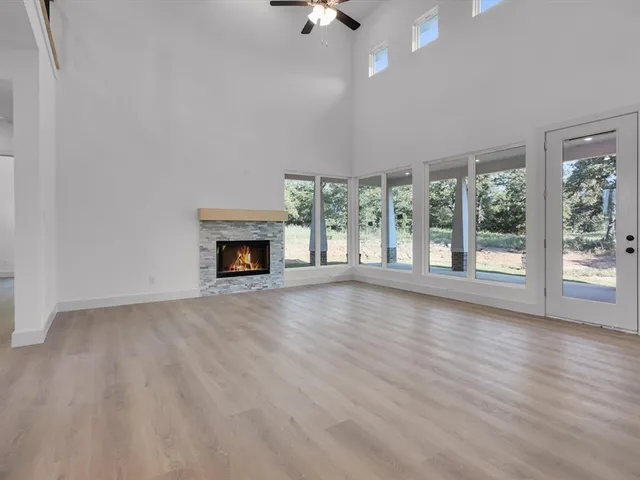wooden floor fireplace and natural light in room