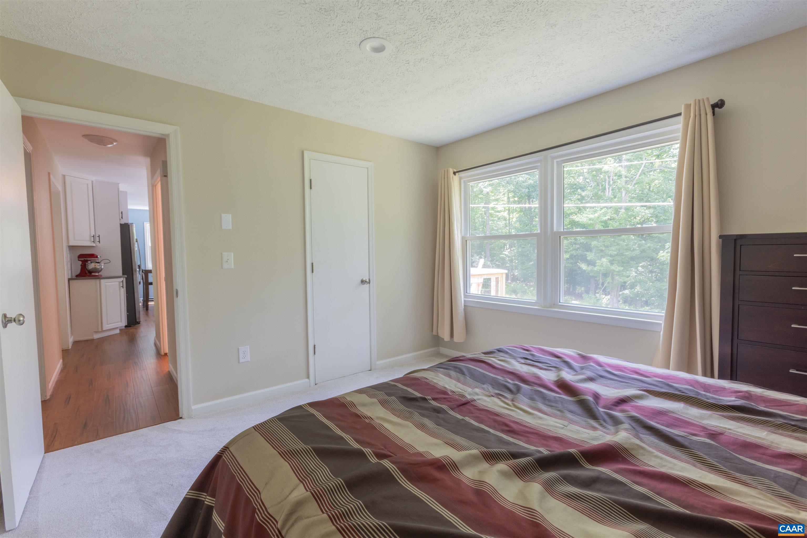 2550 Proffit Road Charlottesville, VA 22911 - Photo 14 of 41 a bedroom with a bed and a large window