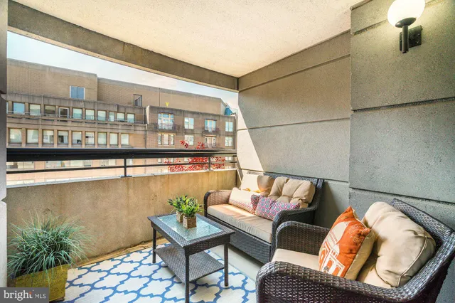 a living room with furniture and a floor to ceiling window