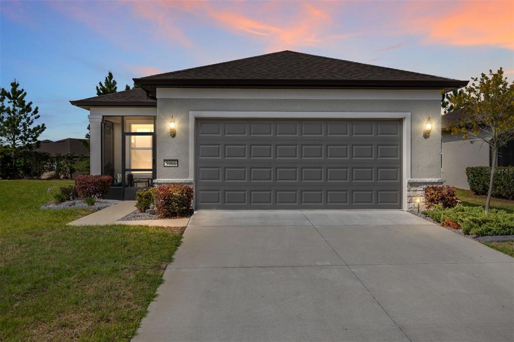 a front view of a house with a yard and garage