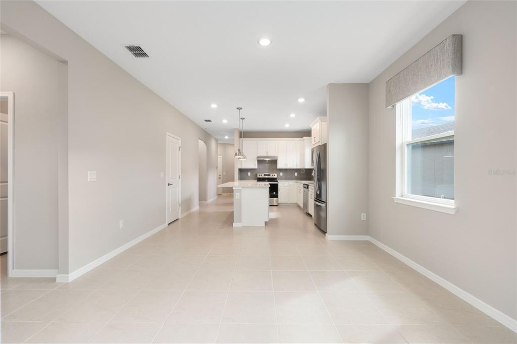 5966 Southwest 93rd Circle Ocala, FL 34481 - Photo 16 of 41 a view of a kitchen with refrigerator and windows