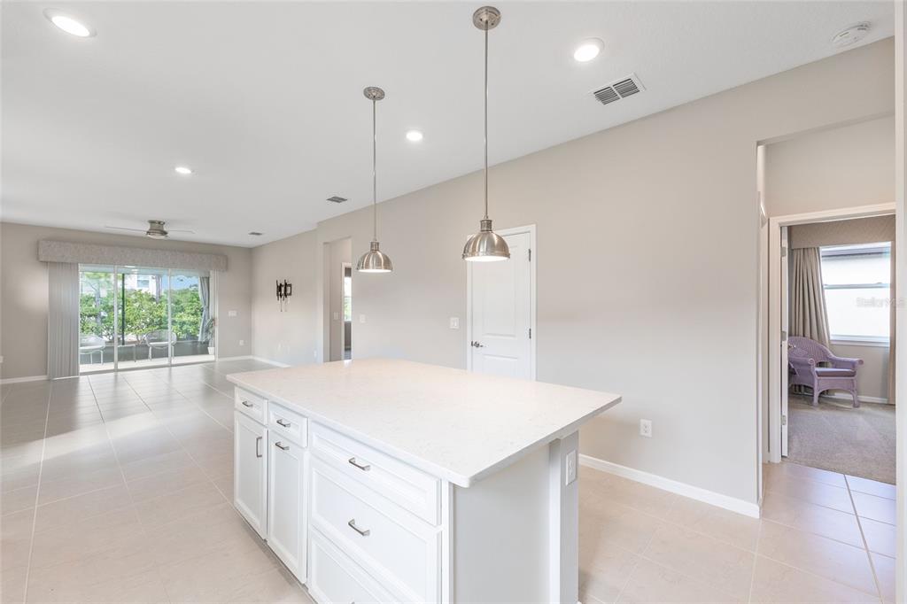 5966 Southwest 93rd Circle Ocala, FL 34481 - Photo 17 of 41 a kitchen with a sink a large window and a wooden floor