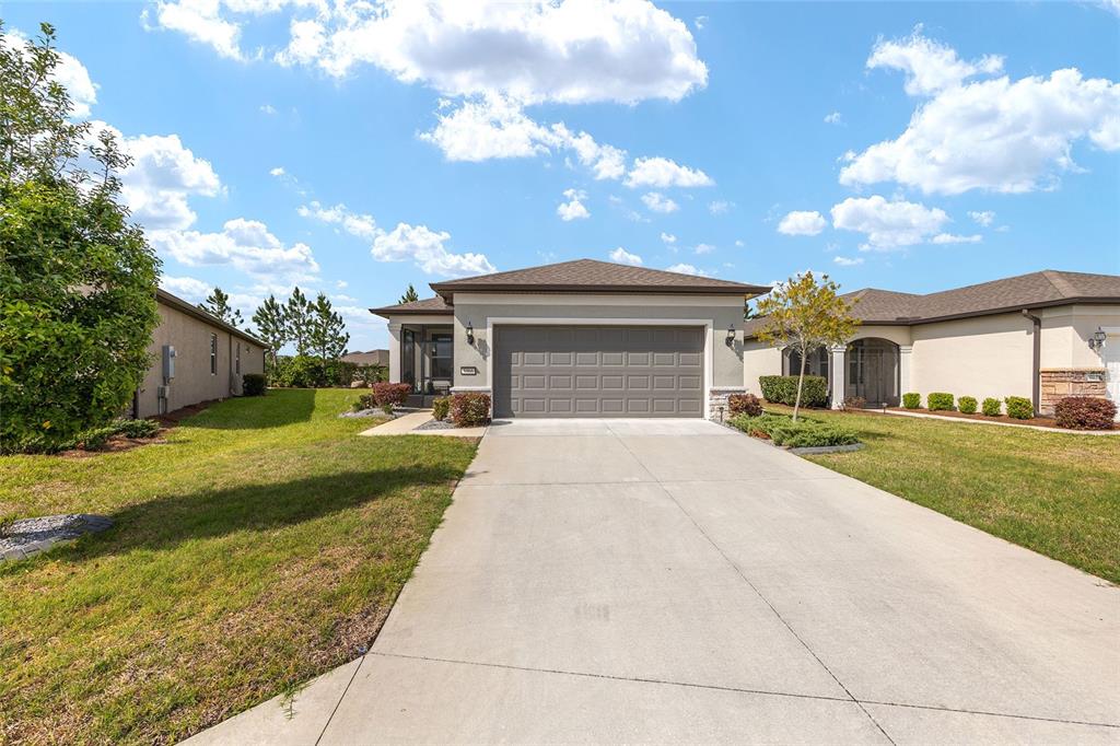 5966 Southwest 93rd Circle Ocala, FL 34481 - Photo 2 of 41 front view of a house with a yard