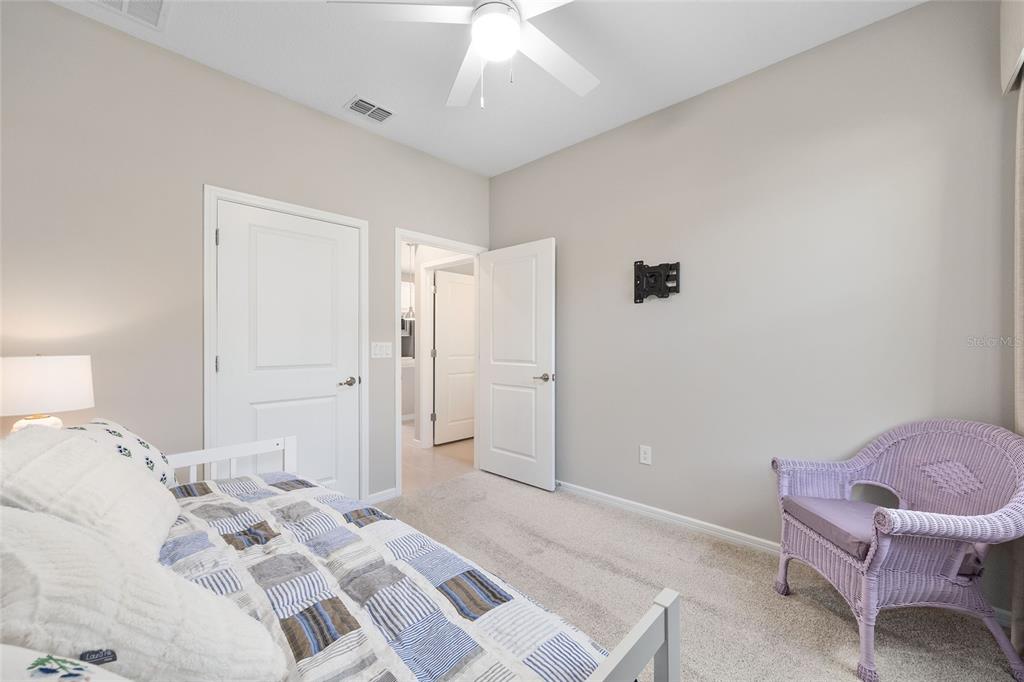 5966 Southwest 93rd Circle Ocala, FL 34481 - Photo 22 of 41 a bedroom with a bed and a chair