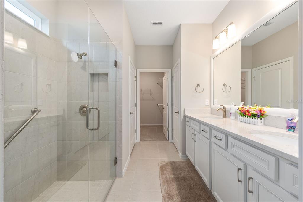 5966 Southwest 93rd Circle Ocala, FL 34481 - Photo 27 of 41 a bathroom with a double vanity sink mirror and shower