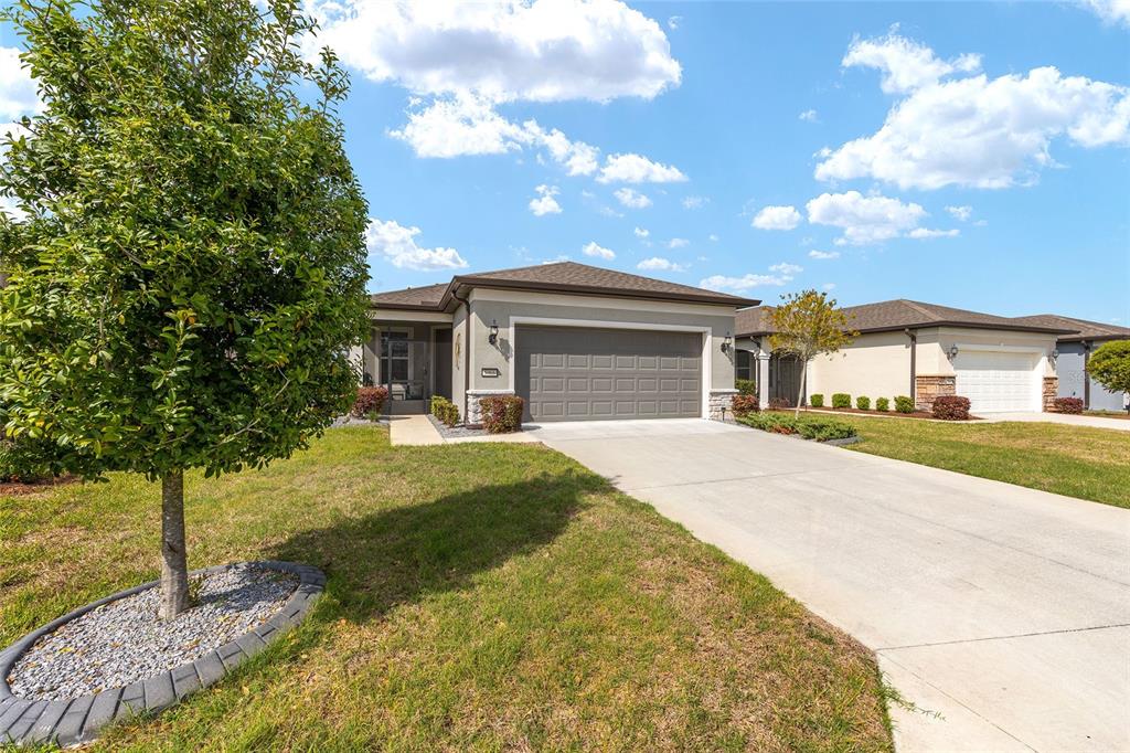 5966 Southwest 93rd Circle Ocala, FL 34481 - Photo 3 of 41 a front view of a house with garden