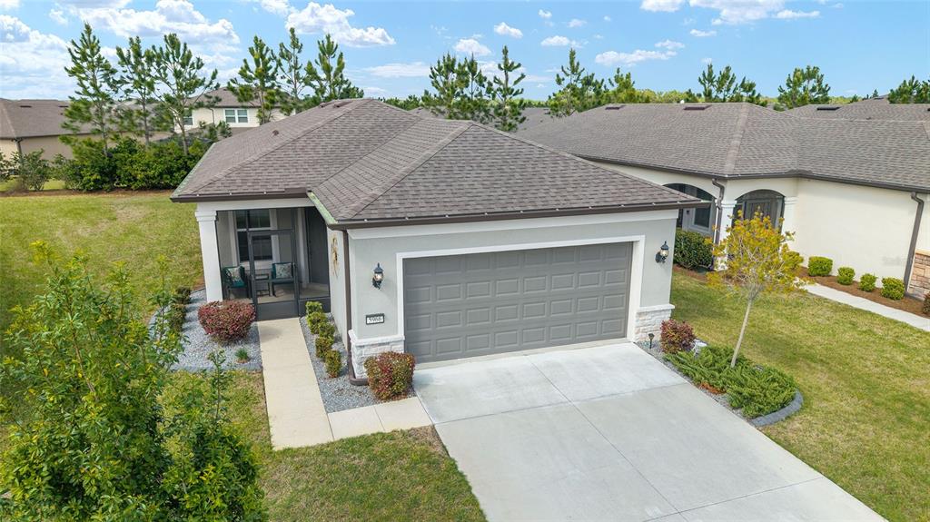 5966 Southwest 93rd Circle Ocala, FL 34481 - Photo 4 of 41 a front view of a house with a yard and garage