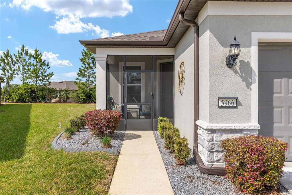 5966 Southwest 93rd Circle Ocala, FL 34481 - Photo 5 of 41 a front view of a house with garden