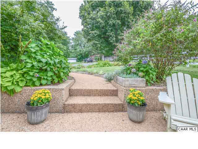3938 Richmond Road Keswick, VA 22947 - Photo 15 of 37 Bask in the fresh air & sunshine as you soak in the gorgeous views of the pasture & barn through rail fencing. The crisp white of the fence & the house trim against the periwinkle blue of the siding has a fresh, fun feel.