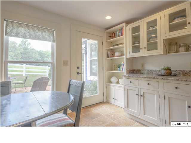 3938 Richmond Road Keswick, VA 22947 - Photo 17 of 37 An oversized entry provides easy flow between the sitting room & kitchen. Awash in character, yet modern in function, this kitchen is ideal. A small island w/butcher block top supplements workspace & provides additional storage w/in & w/pot rack above.