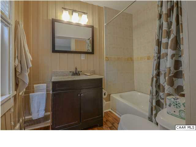 3938 Richmond Road Keswick, VA 22947 - Photo 23 of 37 Small but sweet, this delightful bedroom provides the convenience of one floor living or the option of a guest room separate from the master. Soft daylight flows through windows on two walls, filtered by tree branches & the porch.