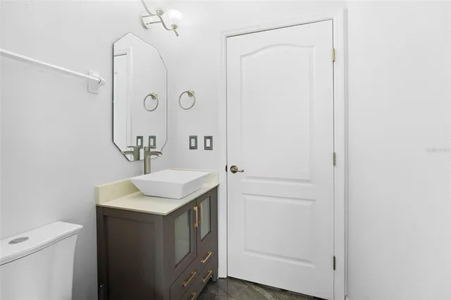 a bathroom with a sink vanity and a mirror