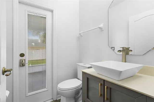 a bathroom with a sink toilet and vanity