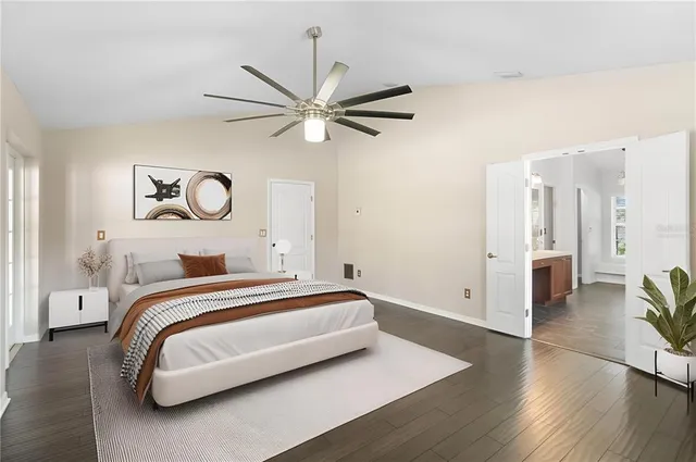 a spacious bedroom with a bed and a chandelier
