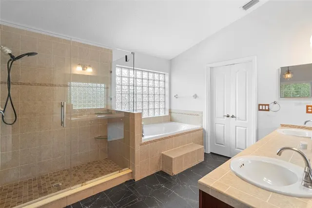 a bathroom with a tub sink toilet and a shower