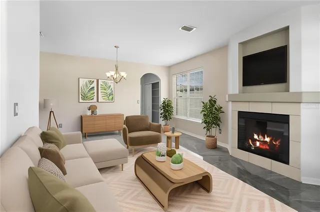 a living room with furniture a flat screen tv and a fireplace