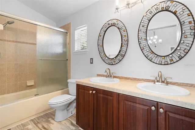 a bathroom with a toilet a sink and a mirror