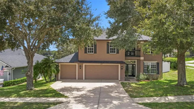 a house that has a tree in front of the house