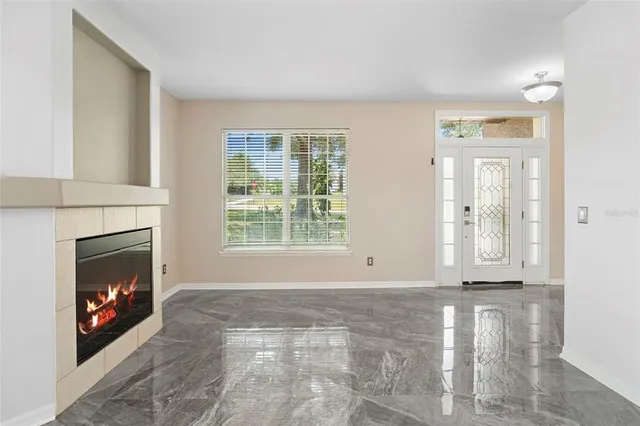 a view of a livingroom with a fireplace and window