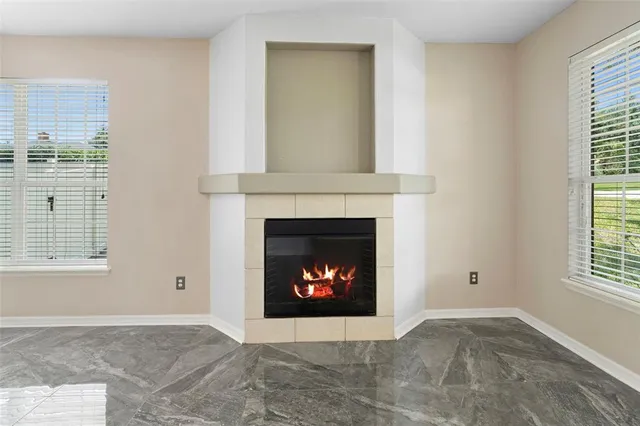 a living room with a fireplace and a fireplace